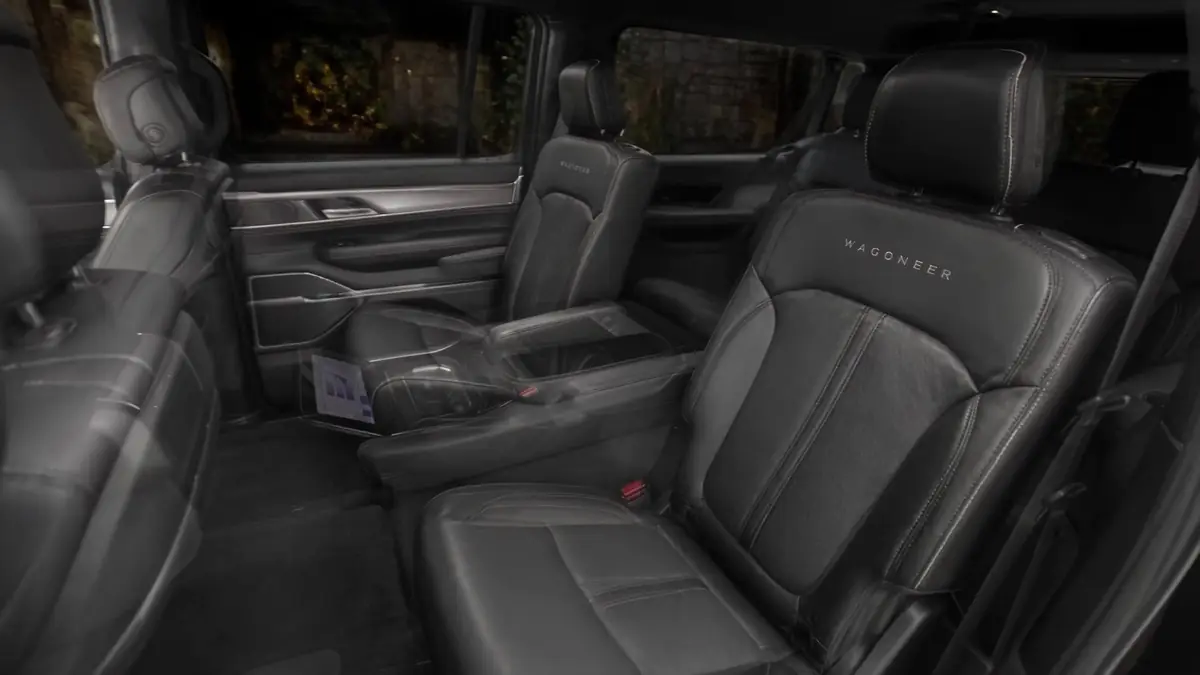 Open rear door of a Jeep Wagoneer showing the leather second-row seats