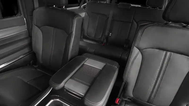Black leather captain's chairs and centre console in the rear of a Jeep Wagoneer